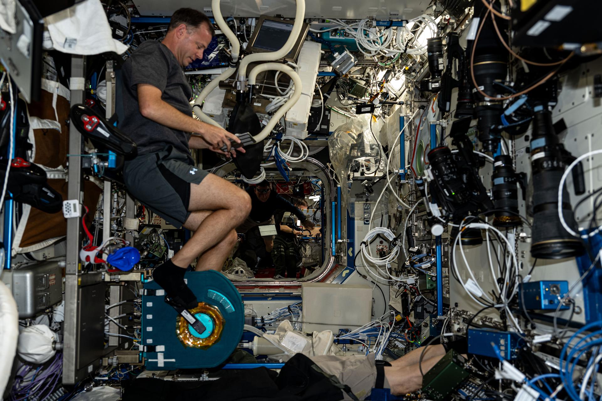 NASA astronaut and Expedition 72 Flight Engineer Nick Hague pedals on the Cycle Ergometer with Vibration Isolation and Stabilization (CEVIS), an exercise cycle located aboard the International Space Station's Destiny laboratory module. CEVIS provides aerobic and cardiovascular conditioning through recumbent (leaning back position) or upright cycling activities.