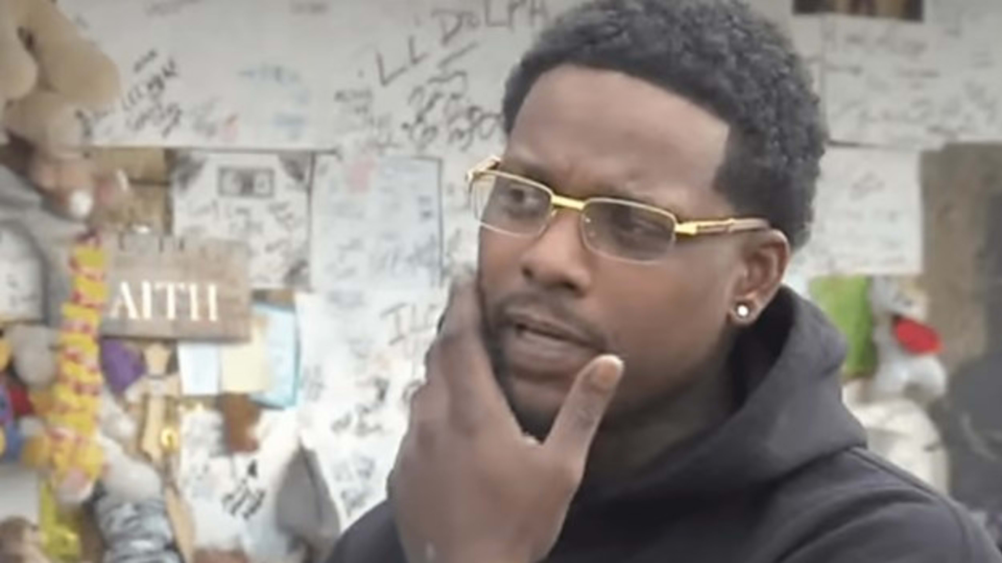 Jeremiah Taylor stands outside of Young Dolph memorial