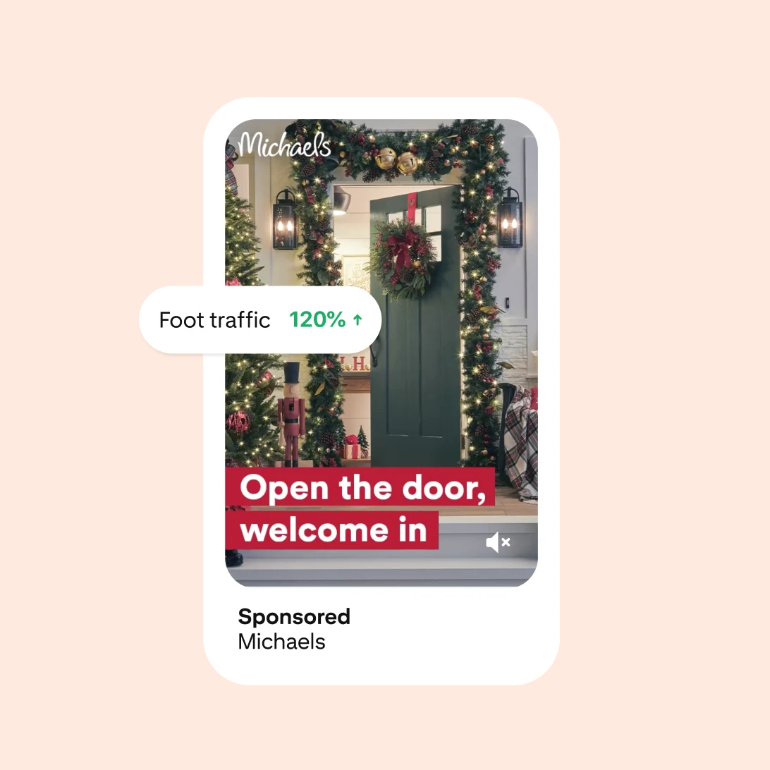 An ad for Michaels shows a green front door that’s decorated with a holiday wreath and garland. An icon shows that foot traffic has increased by 120%.