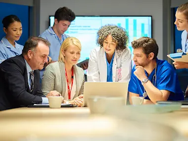 Image depicting a collaboration between business and medical professionals (© Sturti/E+ via Getty Images)