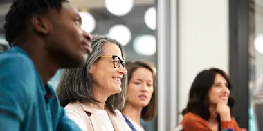 Photo of men and women in a board room (Morsa Images/DigitalVision via Getty Images)