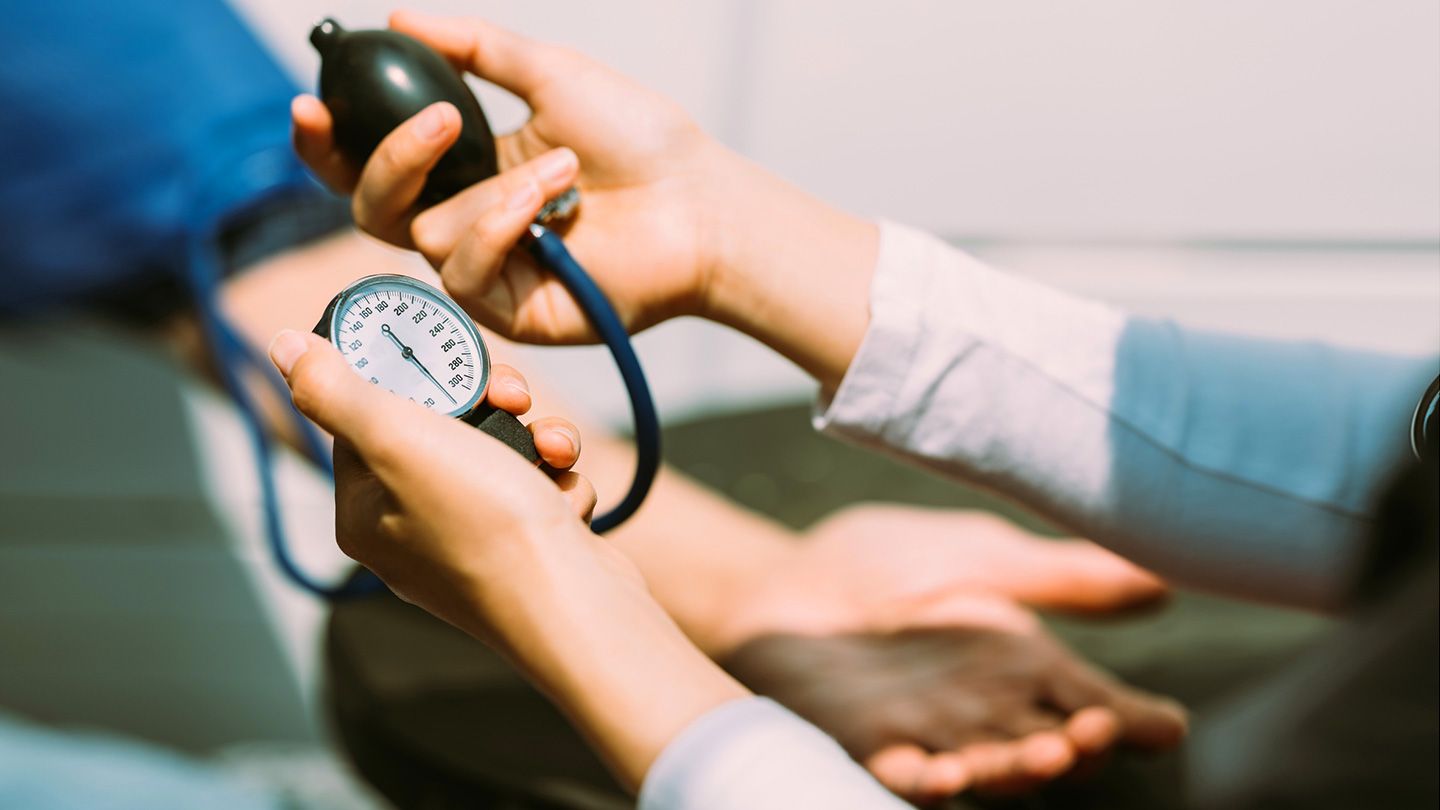 person at doctor monitoring blood pressure