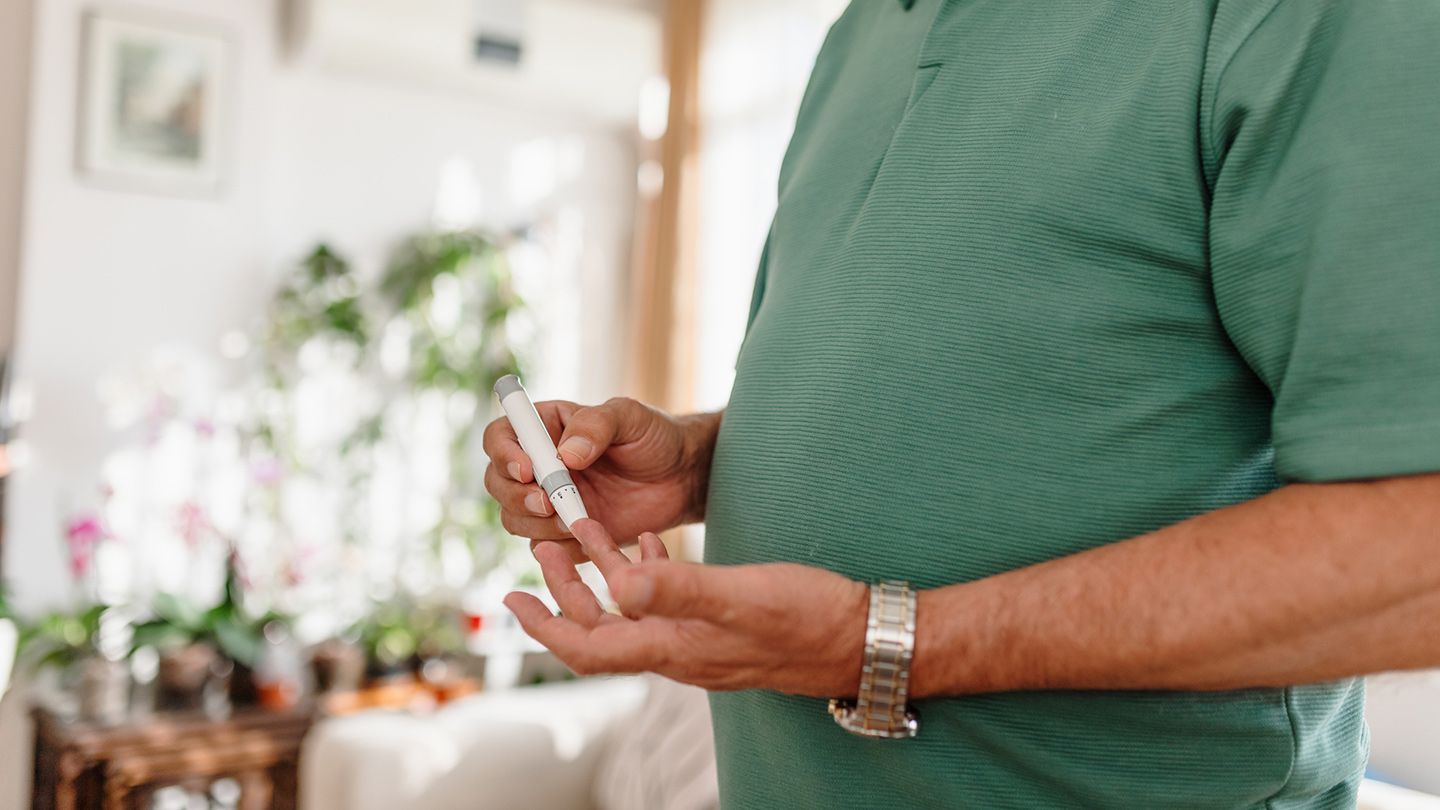 man checking blood sugar insulin levels