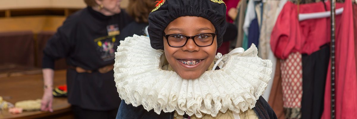 girl smiling and wearing an Elizabethan ruff