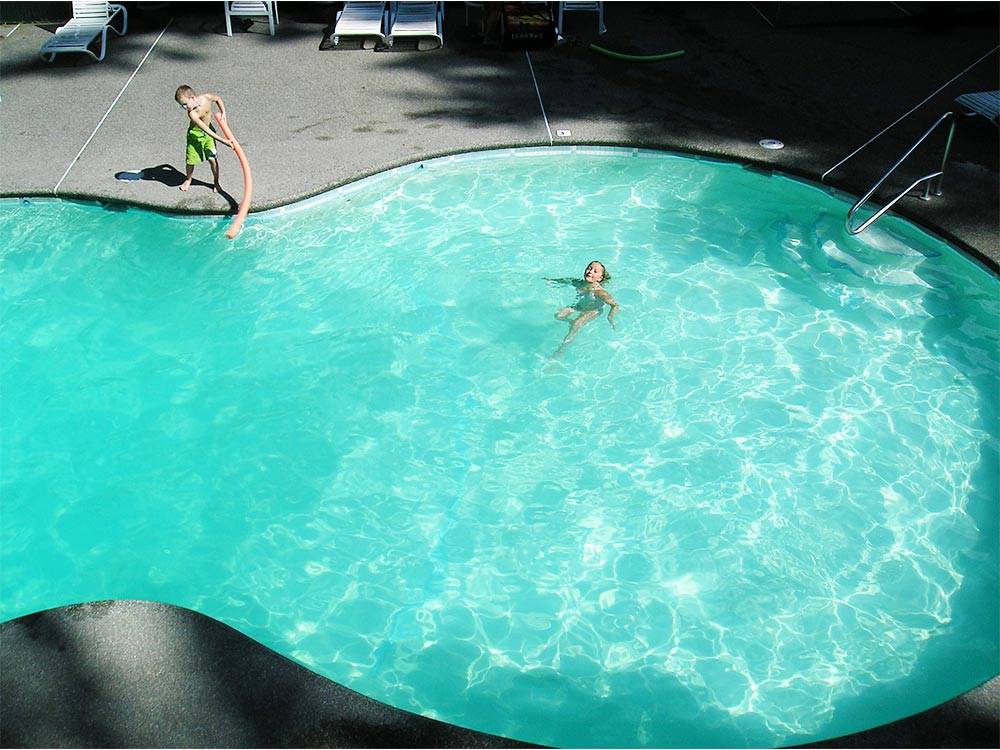 Kids swimming in pool at THOUSAND TRAILS GRANDY CREEK