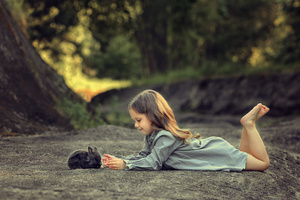 Little Girl Lying Down And Playing With Rabbit (1280x800) Resolution Wallpaper