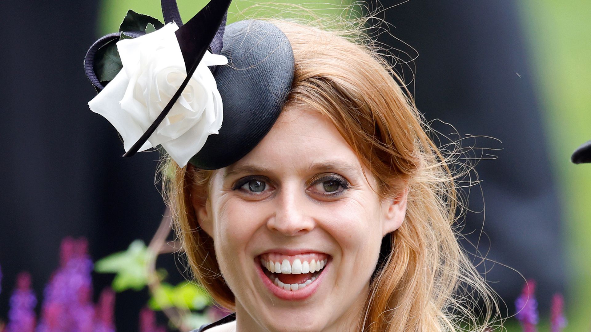 Princess Beatrice laughing in black spotty dress