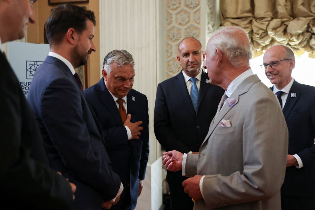 King Charles in a grey suit meeting European leaders including Viktor Orban