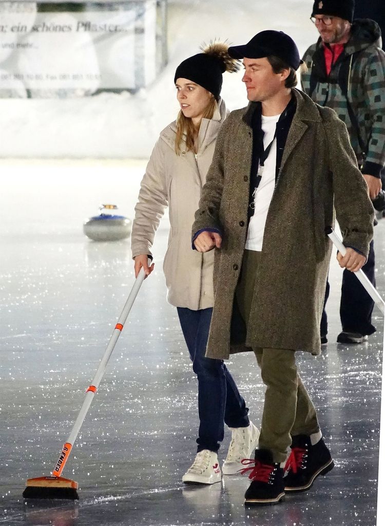 couple taking part in curling 