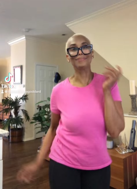 Trisha Goddard dancing in her living room at home in the US