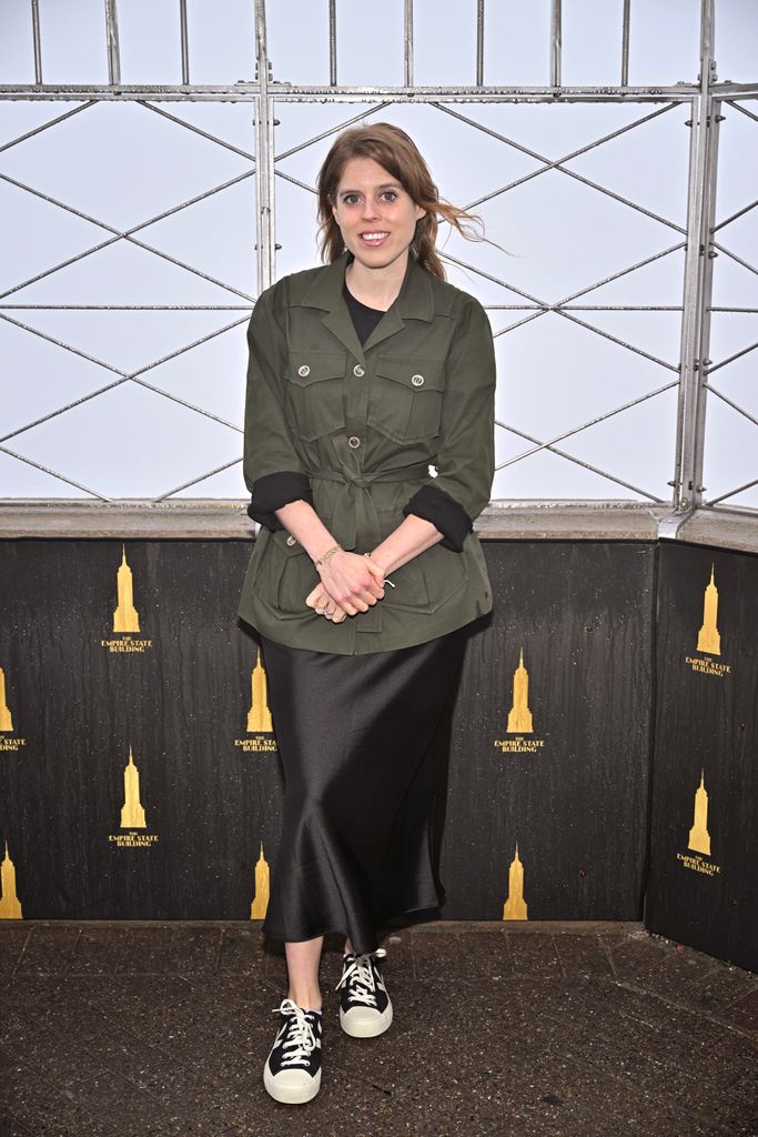 Princess Beatrice in black skirt and khaki jacket