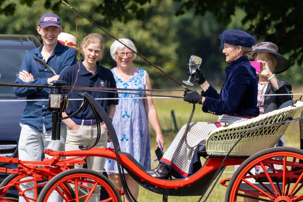 Lady Louise watches Sophie carriage driving with her friend Felix