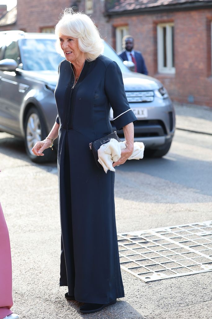 Queen Camilla in a navy blue dress