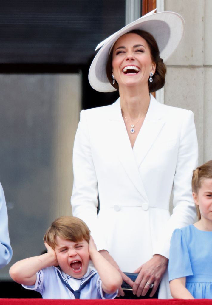 Prince Louis covers his ears as mum Princess Kate laughs as they watch the RAF flypast at Trooping the Colour in 2022