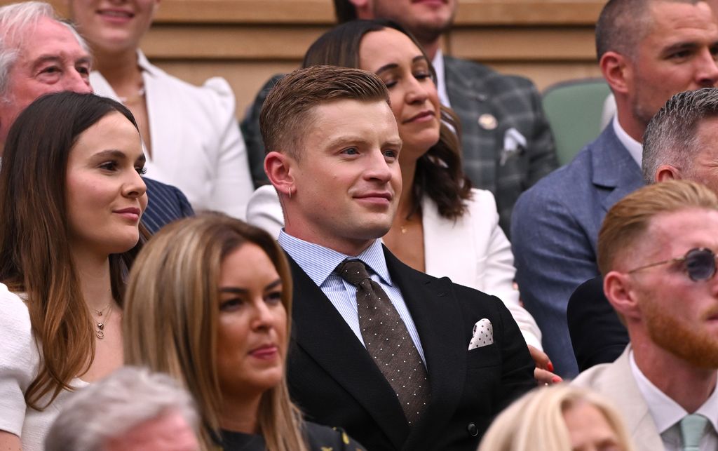 Adam Peaty smiles from the Royal Box with holly ramsay