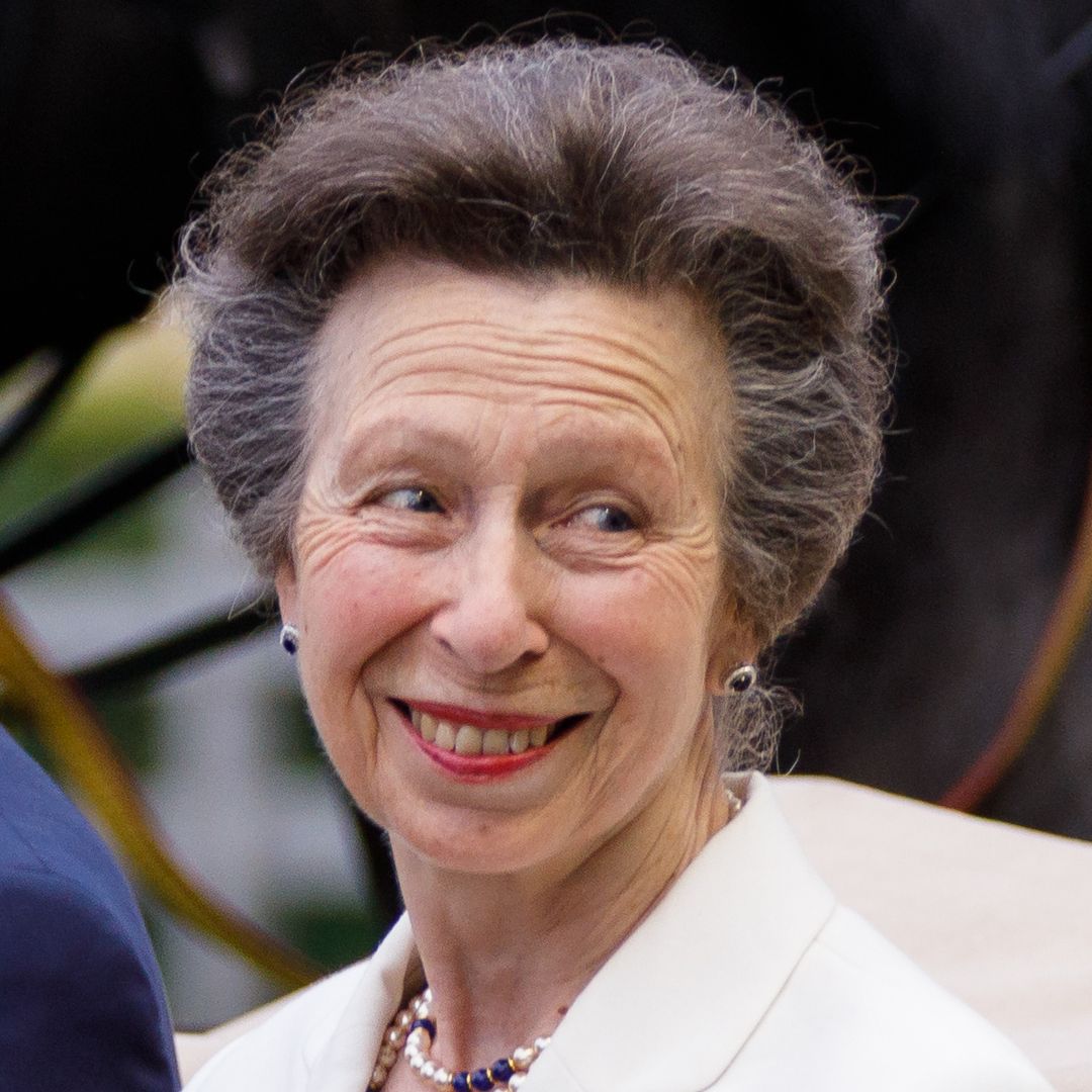 Princess Anne is a vision in satin wedding guest skirt and bridal white accessories