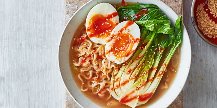 Vegetarian ramen in a bowl with pak choi and boiled egg