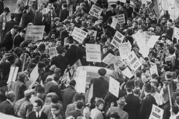 Protestors carrying placards in protest of the reservoir.