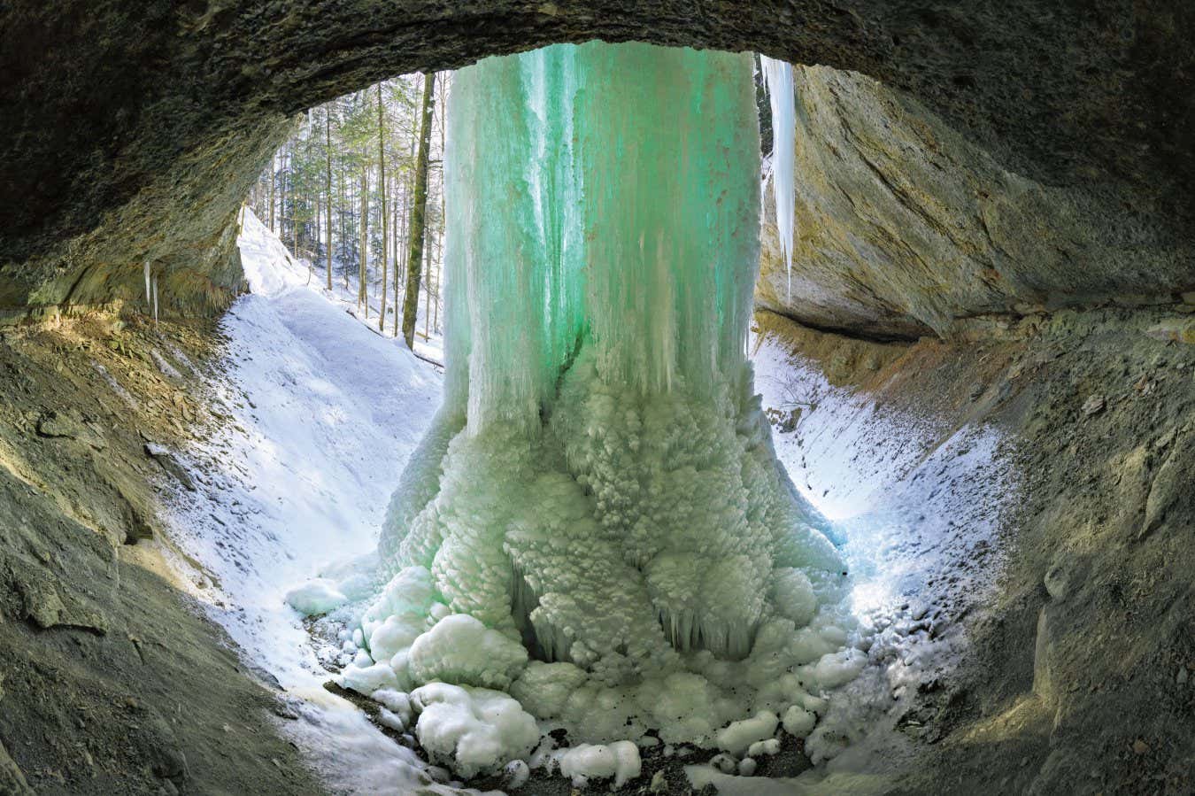 Canton Z?rich, Switzerland Ice has formed around a waterfall near Gibswil. Icicles growing from the top, and ice formations growing from the bottom have coalesced into one continuous column. Page 16 + 17