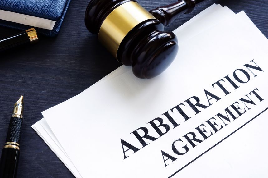 Arbitration agreement and gavel on a desk.