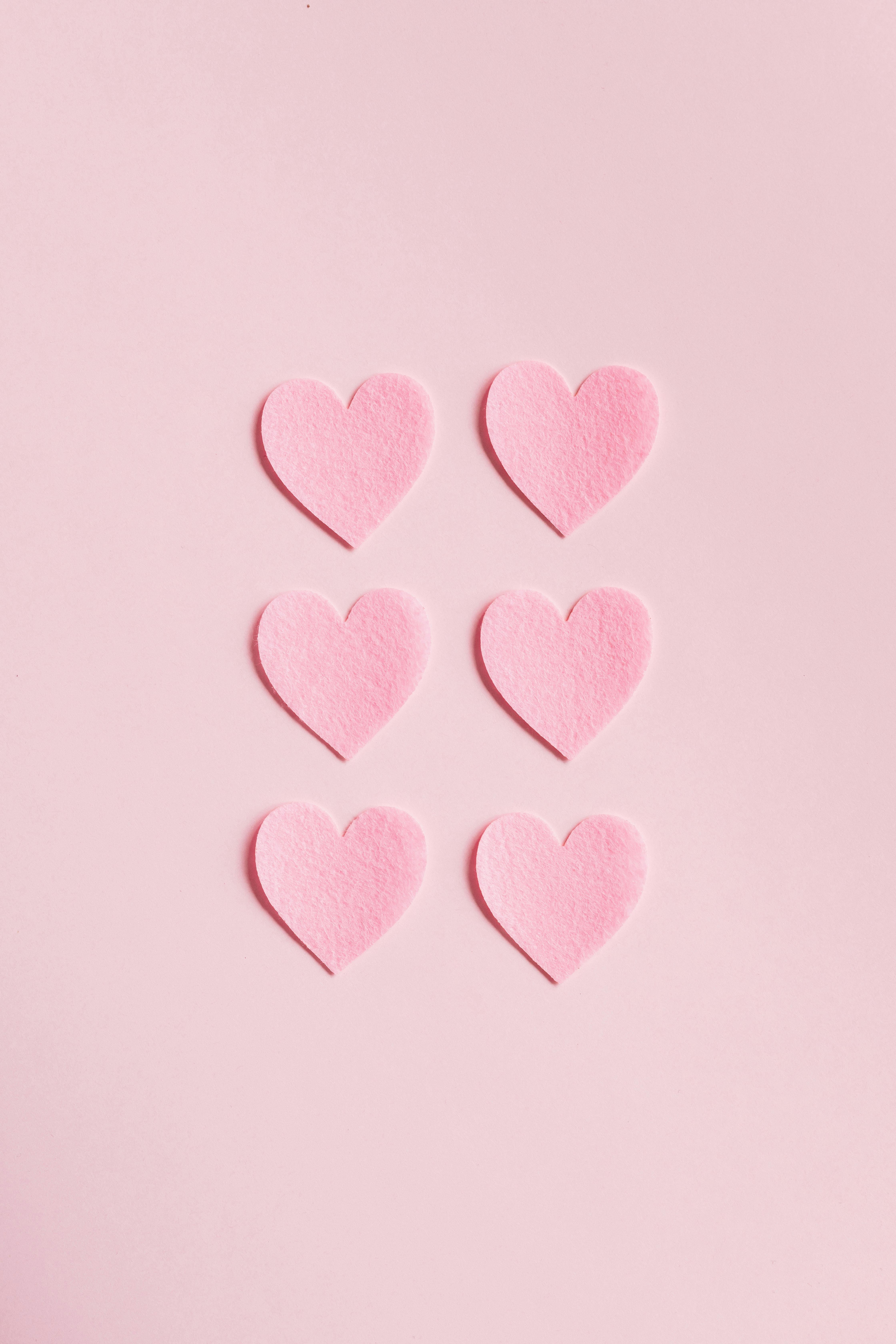 Heart Shaped Cutouts on Pink Background · Free Stock Photo