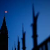 The Canadian flag catches the morning light on the Peace Tower on Parliament Hill in Ottawa on April 16. 