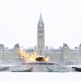 Wide shot of the Centennial Flame with the Parliament building behind