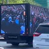 Toronto police's hate crime unit is investigating a truck that was seen displaying anti-Muslim messaging as it drove around the city this week. One of its images of Muslims praying and protesting in Nathan Phillips Square is visible here. 