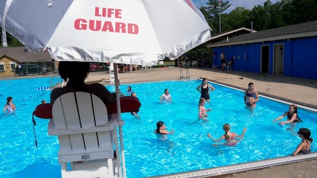 Campers swim in the pool, on June 20, at YMC Camp Kern in Oregonia, Ohio. The employment rate among returning students — those trying to find summer jobs before returning to school full-time in the fall — fell to 46.8 per cent in June. 