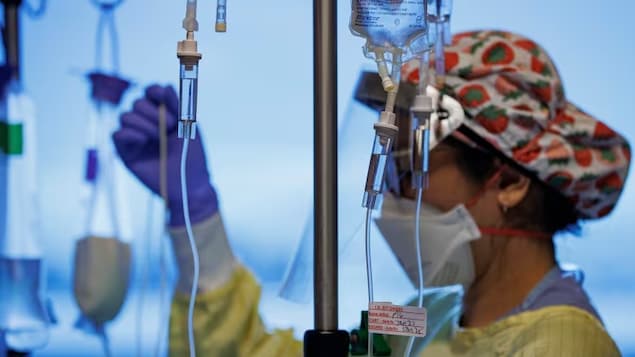 A nurse attends to a COVID-19 patient on a ventilator in the intensive care unit of Humber River Hospital in Toronto in this file photo. (Evan Mitsui/CBC)