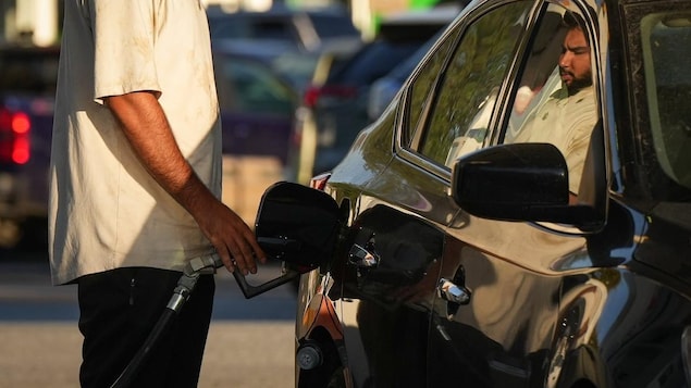 A person is filling up the tank of their vehicle.
