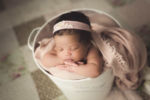 Baby in a bucket pose