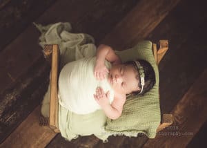 Green and sage vintage set up for newborn bed