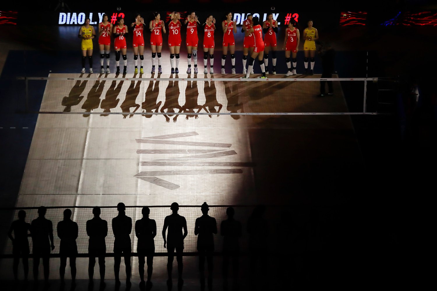  Volleyball players from China, top, and South Korea line up at the start of their Women's Nations League match in Rio de Janeiro, May 14, 2024. (AP Photo/Bruna Prado) 