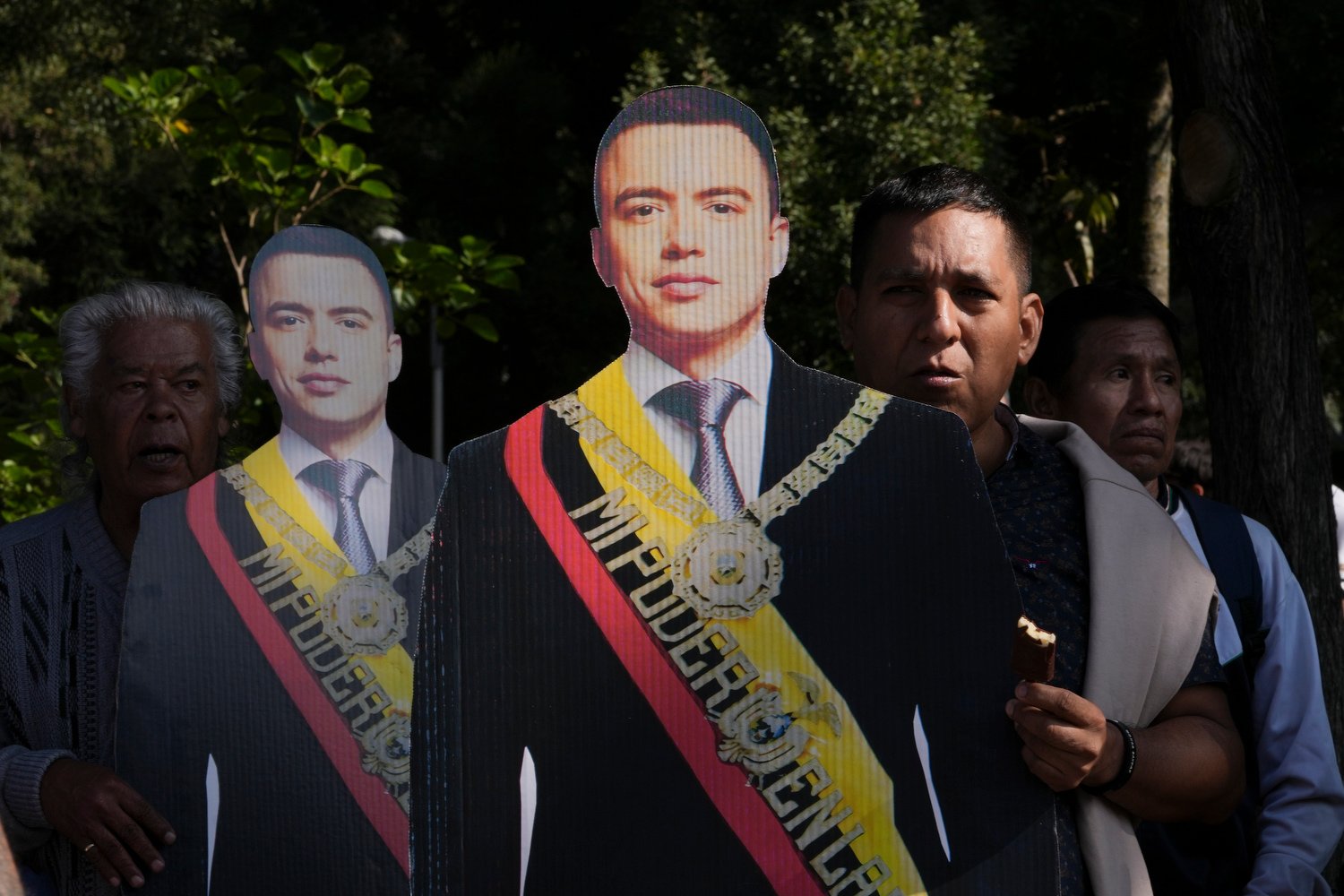  Supporters of Ecuadorean President Daniel Noboa hold cut-outs of him near the National Assembly where he gives his first report to the nation after six months in office in Quito, Ecuador, May 24, 2024. (AP Photo/Dolores Ochoa) 