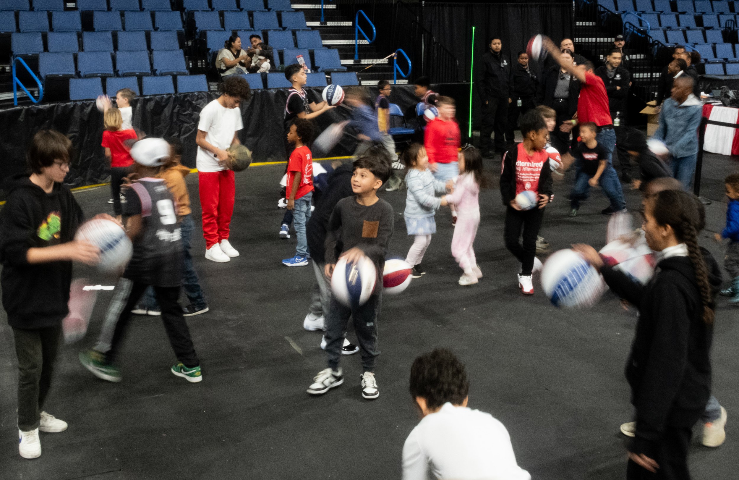  Children down on the end of the court playing with their ball at Toyota Arena in Ontario, Calif. Fans where allowed to go down to the court during halftime of the Harlem Globetrotters and Washington Generals game on Monday, Feb.19, 2024. (Danilo Per