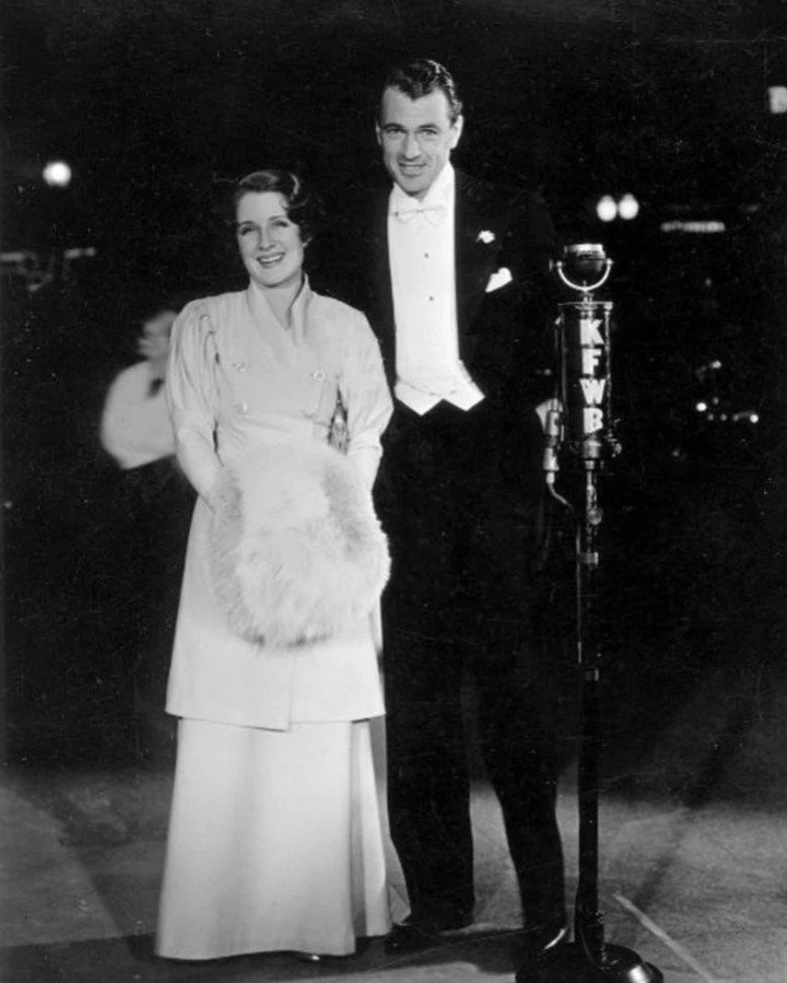 Elegance on full display: Gary Cooper and Norma Shearer arriving in style at a Hollywood premiere. Norma, celebrated as the 'Queen of MGM,' was a pioneer in breaking barriers for women in film, while Gary's timeless charm speaks for itself. A golden 