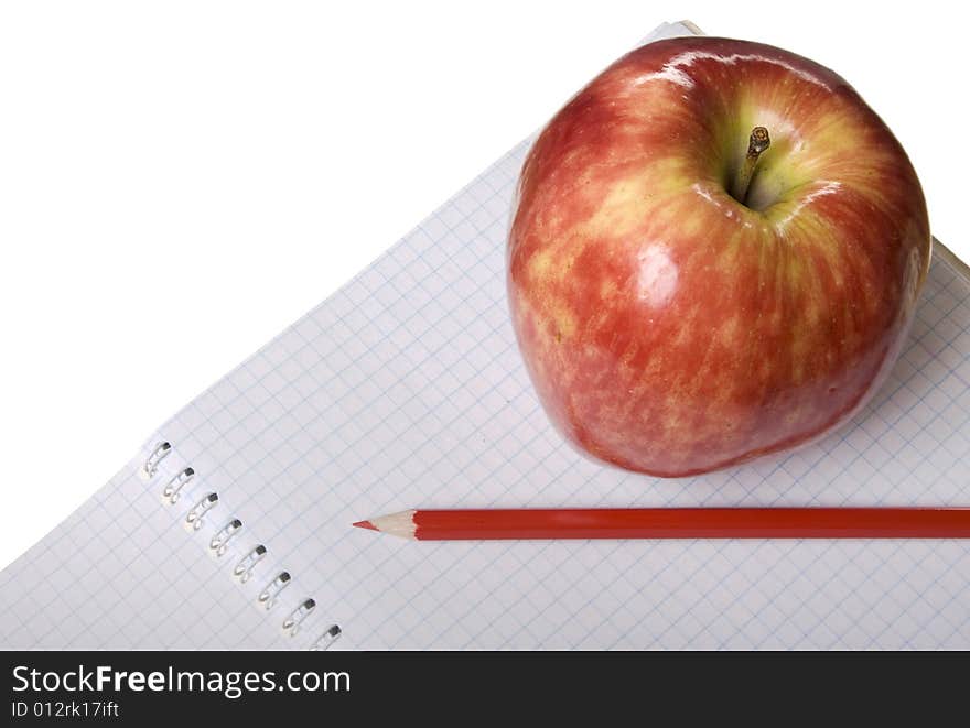 Red apple with notebook and red pencil