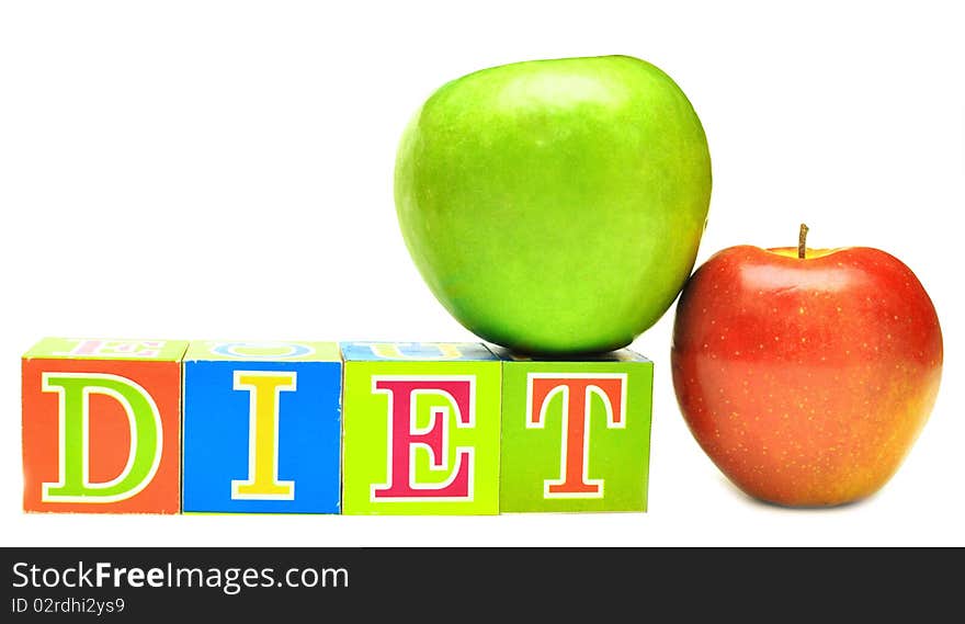 Green and red apple and cubes with letters in front of a white background - diet. Green and red apple and cubes with letters in front of a white background - diet