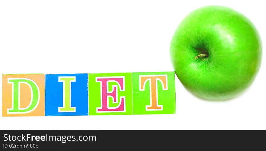 Green apple and cubes with letters in front of a white background - diet. Green apple and cubes with letters in front of a white background - diet