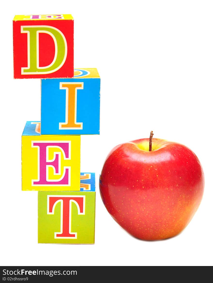 Red apple and cubes with letters in front of a white background - diet. Red apple and cubes with letters in front of a white background - diet