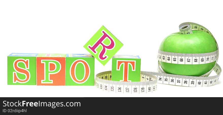 Tape measure wrapped around apple green and cubes with letters - sport. Tape measure wrapped around apple green and cubes with letters - sport