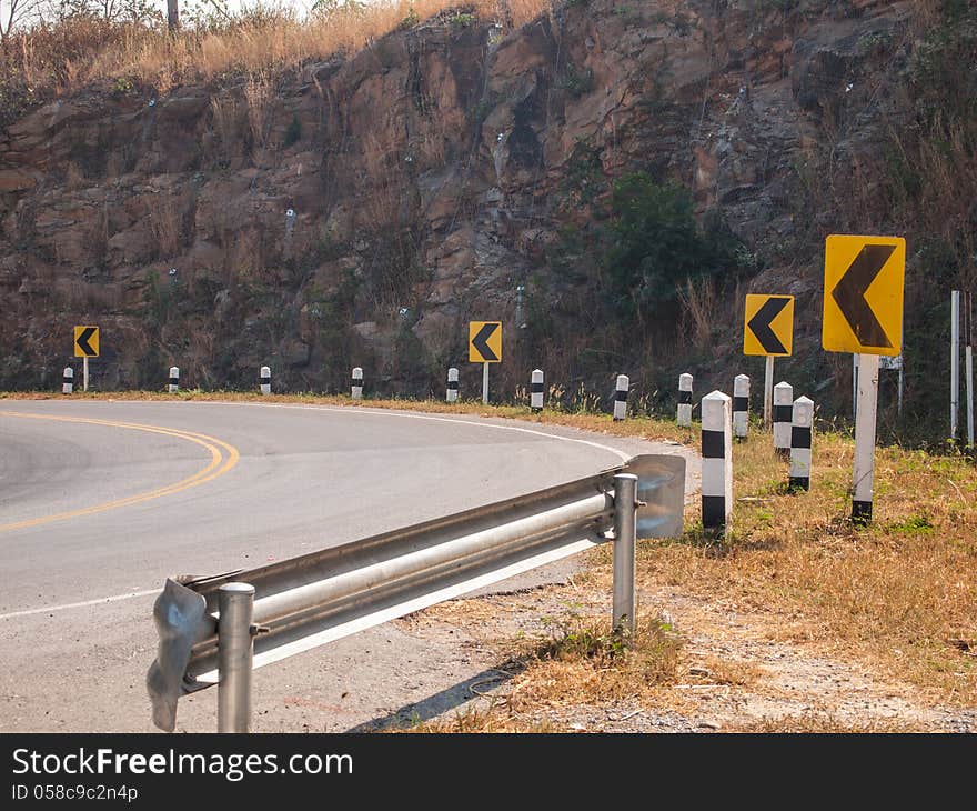 Yellow traffic sign, turn left.