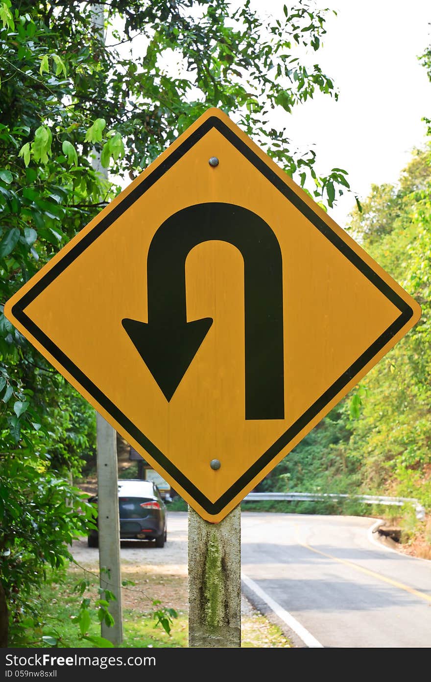 U-turn symbol Road in rustic city in Thailand