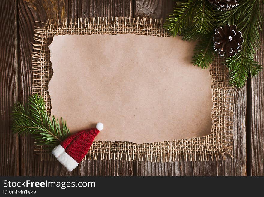 Christmas letter, list, congratulations on a wooden background. free space, mockup new Year. Spruce branches and decoration with their own hands. Cheap greetings