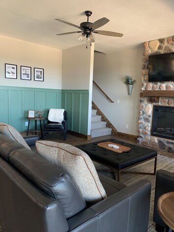 Downstairs living room with two leather couches