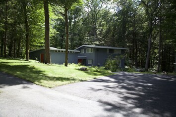 Set back from the quiet road, the house offers a peaceful retreat from the city.