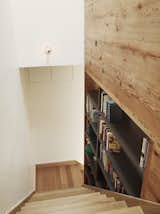 Creating a library along a staircase out of open shelving means that the books can be accessed from both the staircase and the stair hall on the other side.