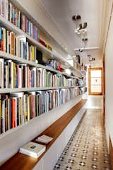 You may think that a library has to be its own room, but books can be stored and read just about anywhere. Lining a hallway with books turns it into a library that you’ll walk through, and be inspired by, every day. Cabinets below provide extra storage and even a place to sit and read.&nbsp;