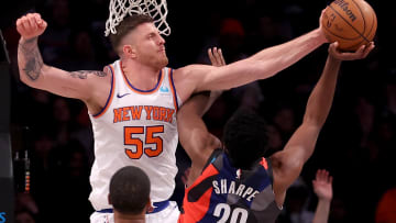 Dec 20, 2023; Brooklyn, New York, USA; New York Knicks center Isaiah Hartenstein (55) blocks a shot by Brooklyn Nets center Day'Ron Sharpe (20) during the second quarter at Barclays Center. Mandatory Credit: Brad Penner-USA TODAY Sports